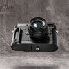 The Owlkrown FlexGrip fitted to a Leica M10, seen from the side on a concrete ground