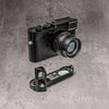 A Leica M10 with the FlexGrip below it, both on a concrete ground