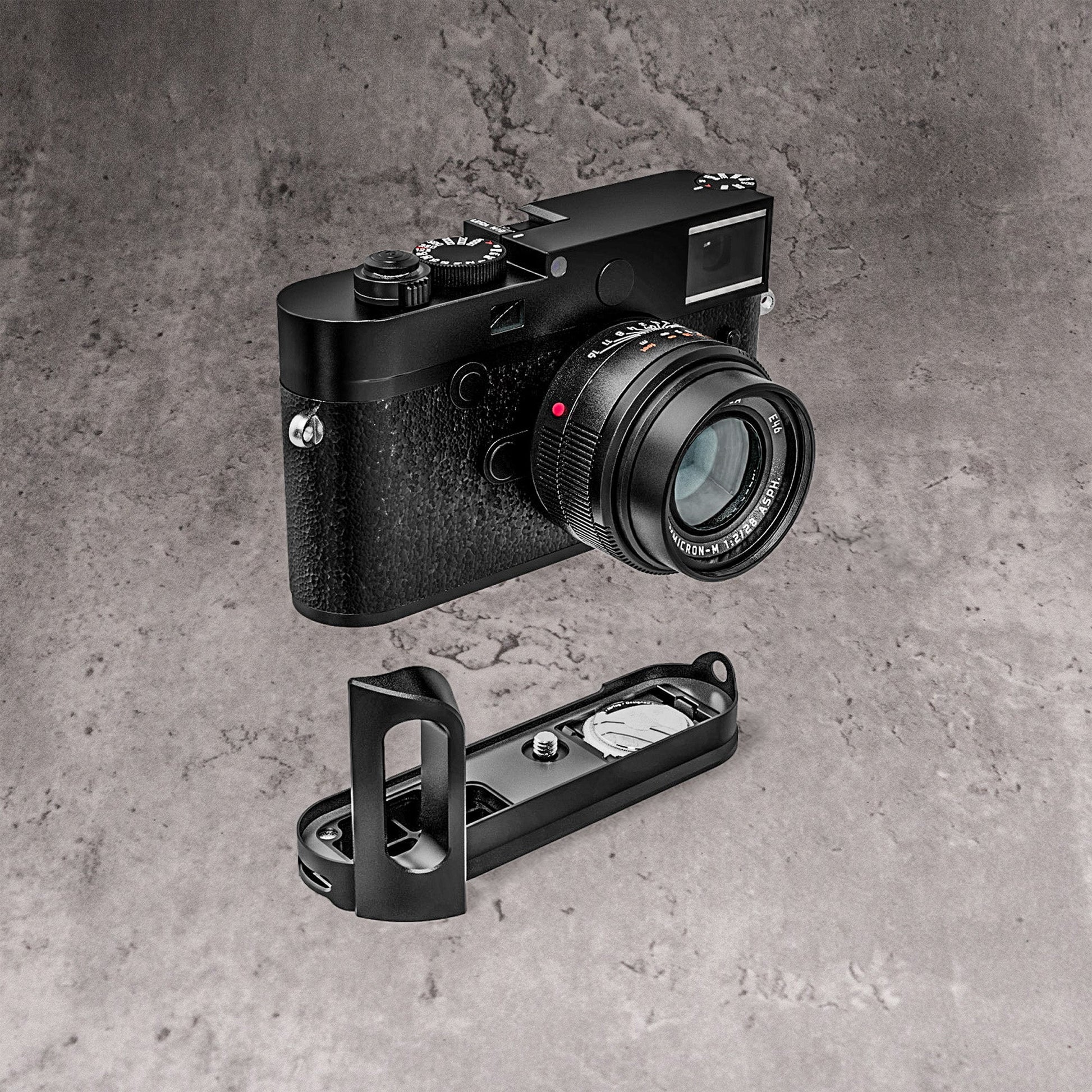 A Leica M10 with the FlexGrip below it, both on a concrete ground