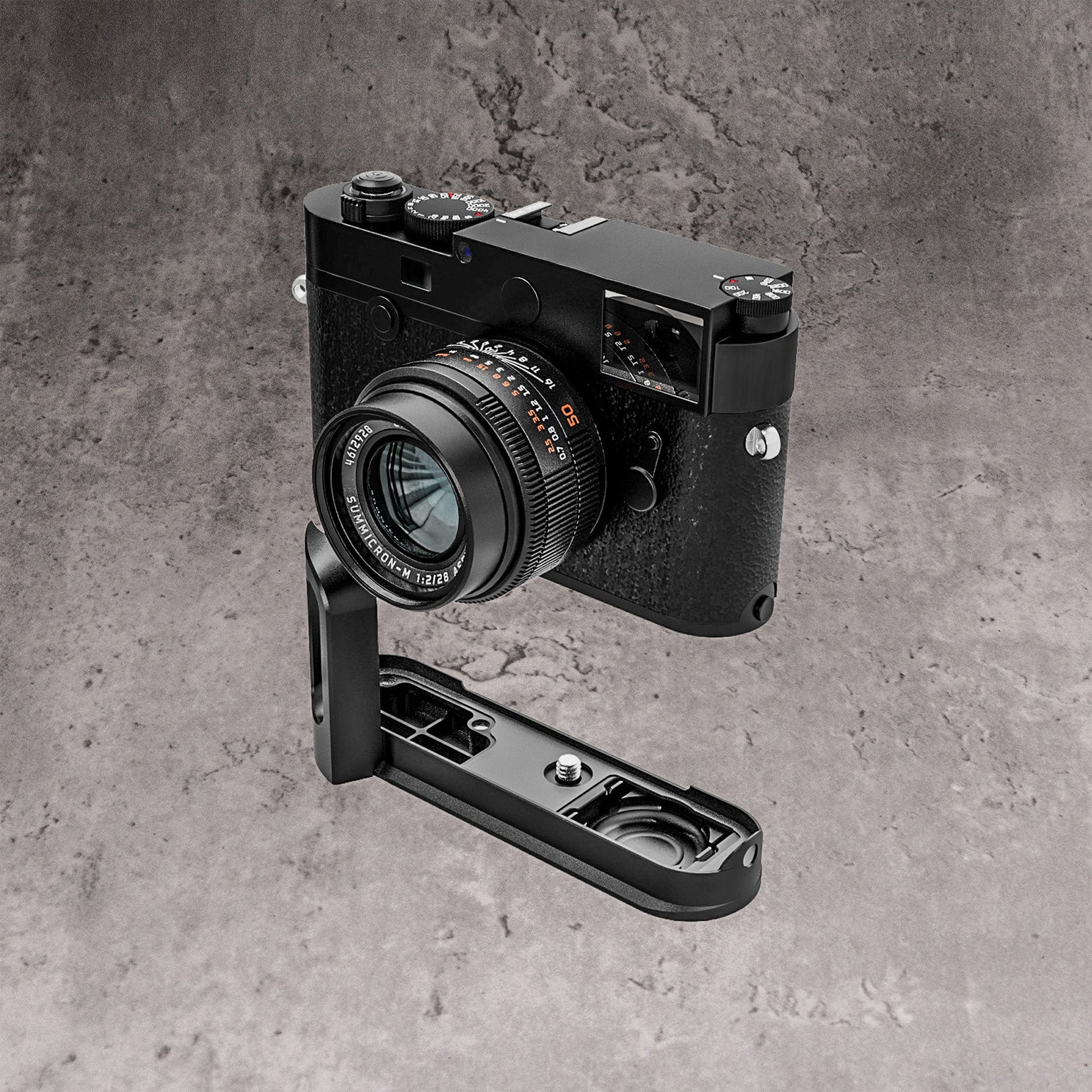A Leica M10 seen at three quarters with the FlexGrip below it