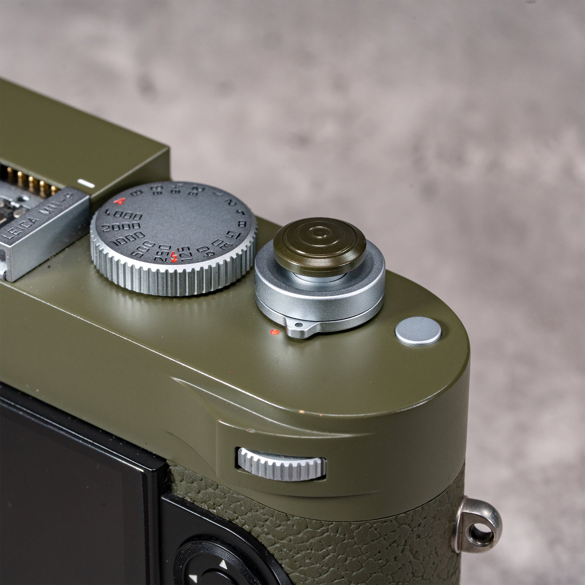 Safari Shutter Topper beside the shutter speed dial on an olive Leica M top plate
