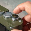 A finger resting on the Safari Shutter Topper, showing the added grip and shutter feel