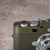Owlkrown Safari Shutter Topper seated flush on an olive Leica M top plate