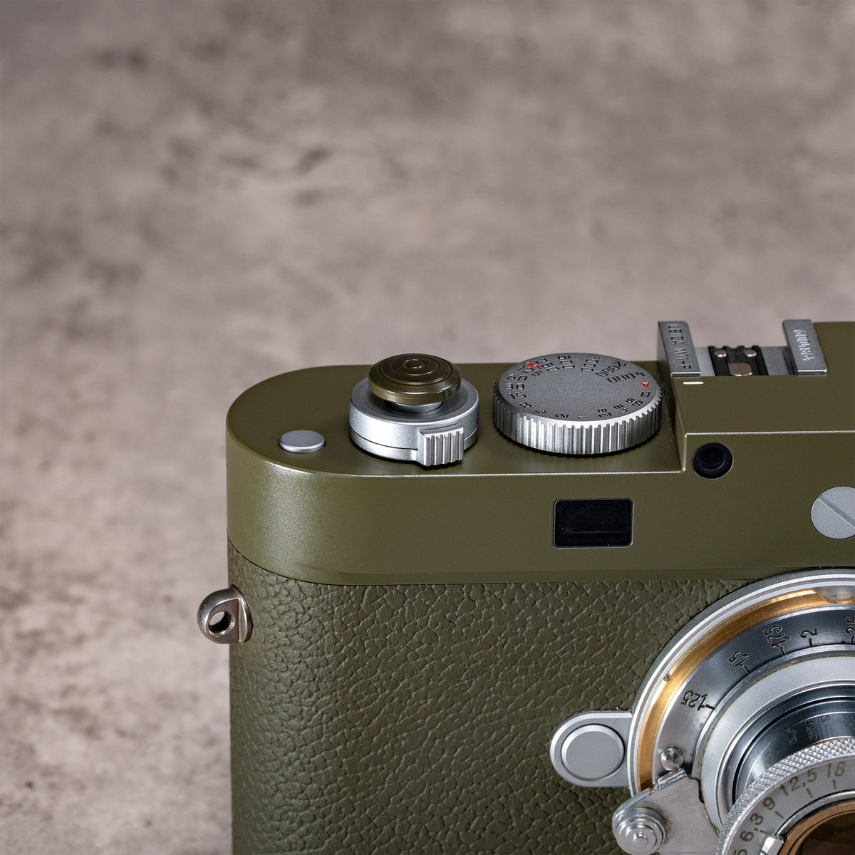 Owlkrown Safari Shutter Topper seated flush on an olive Leica M top plate