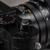 Black Cerakote Shutter Topper fitted to a black Leica M camera, angled view with lens and strap lug