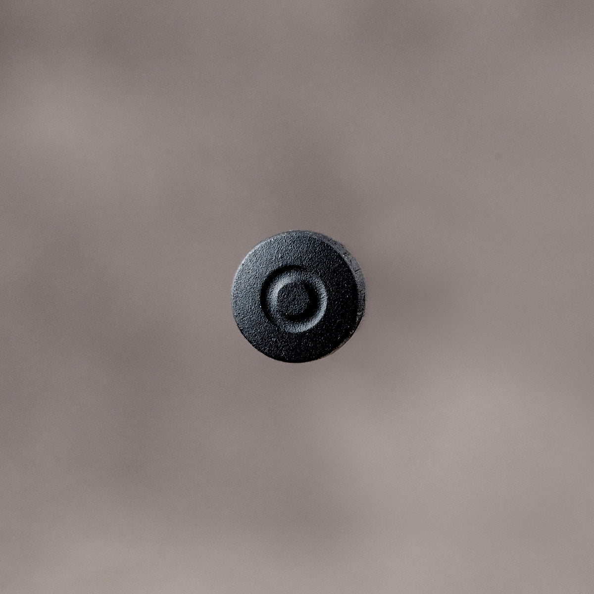 Owlkrown Shutter Topper in Black Cerakote, 7.25 mm, top view of the textured concave face