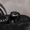 Black Cerakote Shutter Topper seated flush in the shutter release of a black Leica M rangefinder