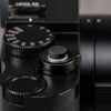Black Cerakote Shutter Topper on a black Leica M top plate with shutter speed dial and lens in frame