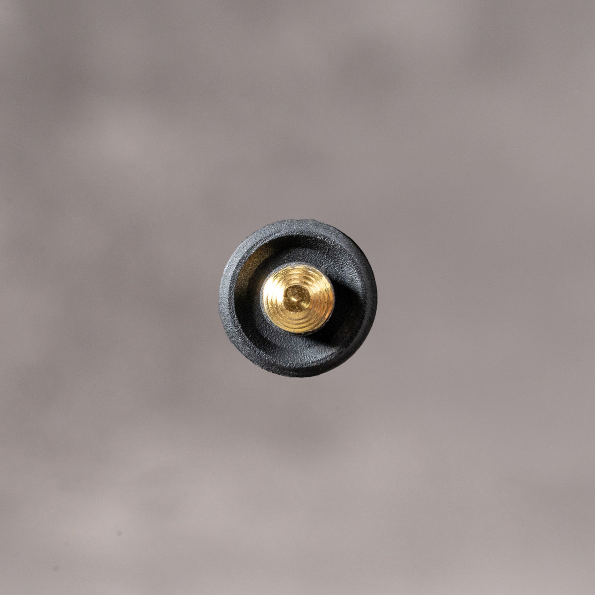 Underside of the Black Cerakote Shutter Topper showing the recessed solid brass thread, 7.25 mm