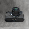 A Leica in the Buffalo SlimCase seen from underneath with a black lens fitted