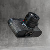 A black Leica in the Buffalo SlimCase, tilted to show the cutout in the base