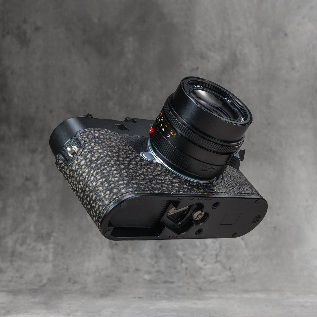 A black Leica in the Buffalo SlimCase, tilted to show the cutout in the base