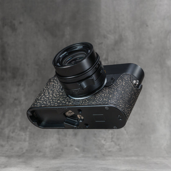 A black Leica in the Buffalo SlimCase from below, base door open