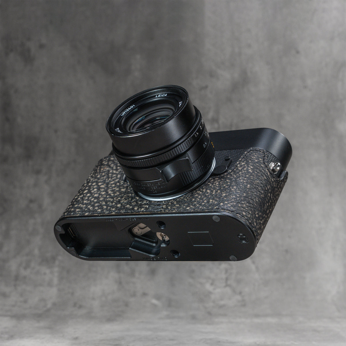 A black Leica in the Buffalo SlimCase from below, base door open