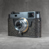 A Leica M11 in the Buffalo SlimCase seen from the opposite front corner