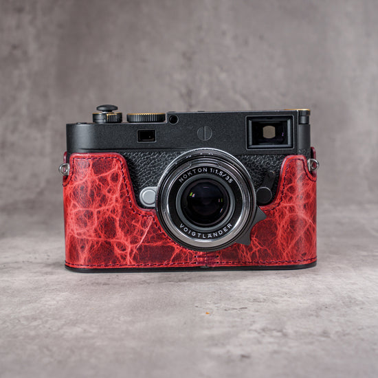 A Leica M11 in the Hot Lava SlimCase seen straight on from the front