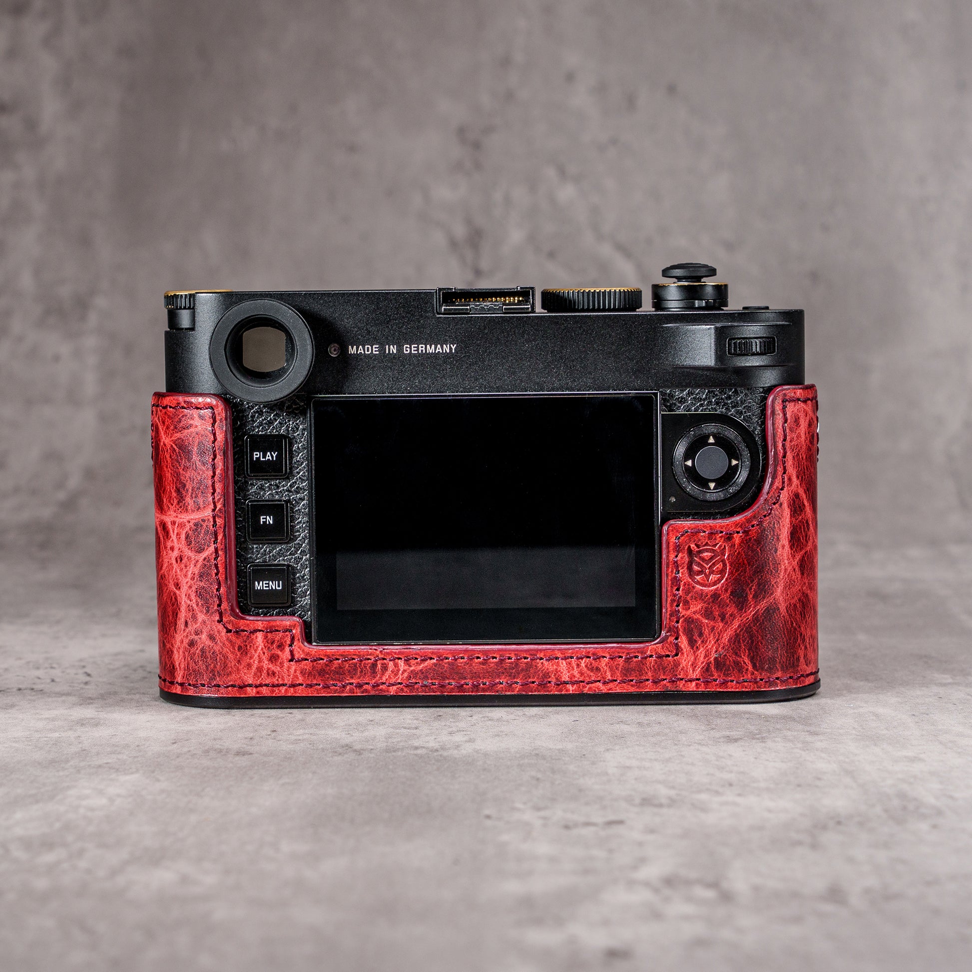The back of a Leica M11 in the Hot Lava SlimCase, controls left clear of the leather