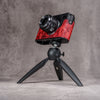 A Leica M11 in the Hot Lava SlimCase mounted on a tabletop tripod