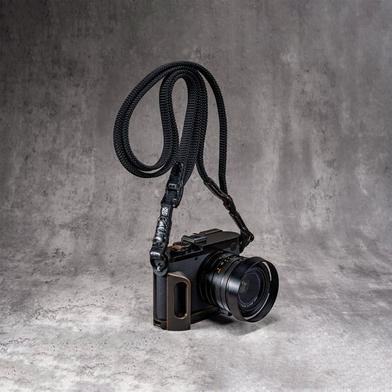 Travel Kit for Leica Q2 and Q3 in Black Patina, camera on the strap