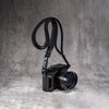 Travel Kit for Leica Q2 and Q3 in Black Patina, camera on the strap