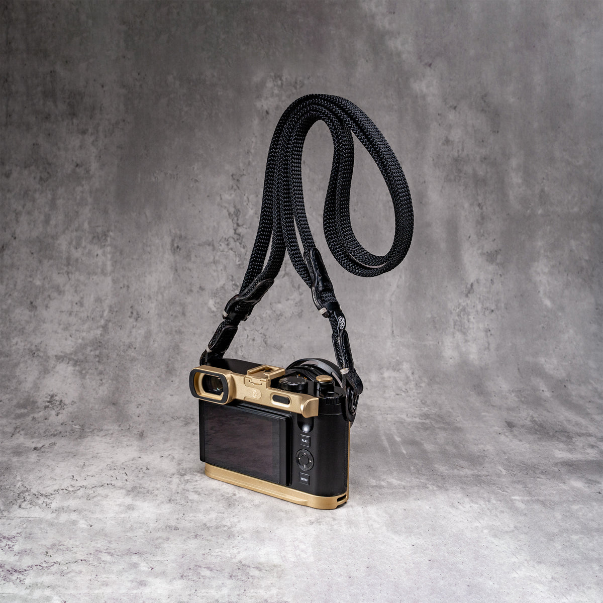 Travel Kit for Leica Q2 and Q3 in Solid Brass, camera on the strap