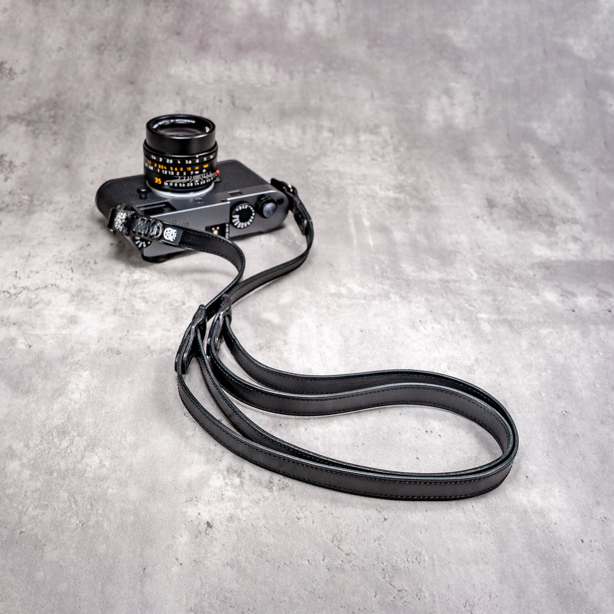 Trailflex Leather strap in Stealth at full length, attached to a Leica M