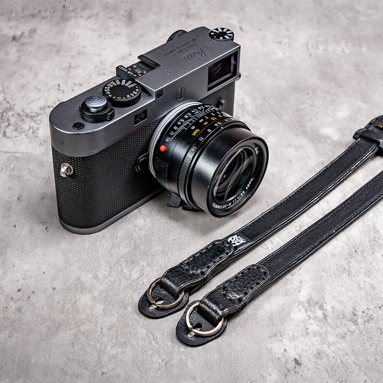 Stealth leather strap ends with split rings beside a Leica M