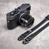 Stealth leather strap ends with split rings beside a Leica M