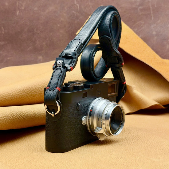 Leica M standing upright with the Trailflex Leather strap in Black with Red Accent
