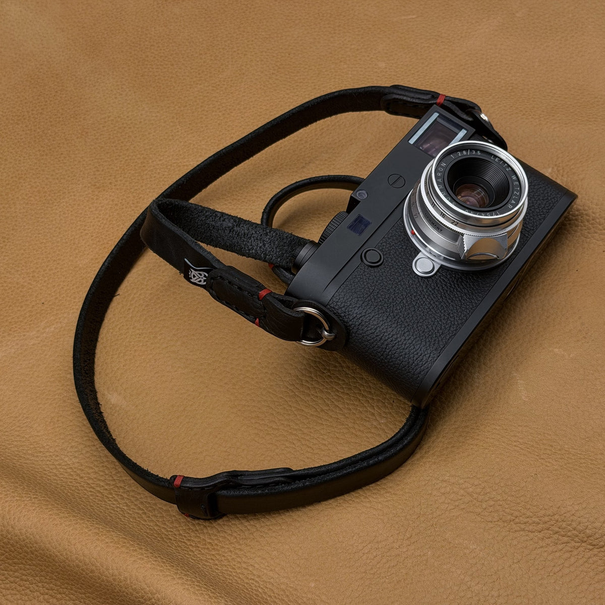 Trailflex Adjustable Leather Camera Strap laid out around a Leica M