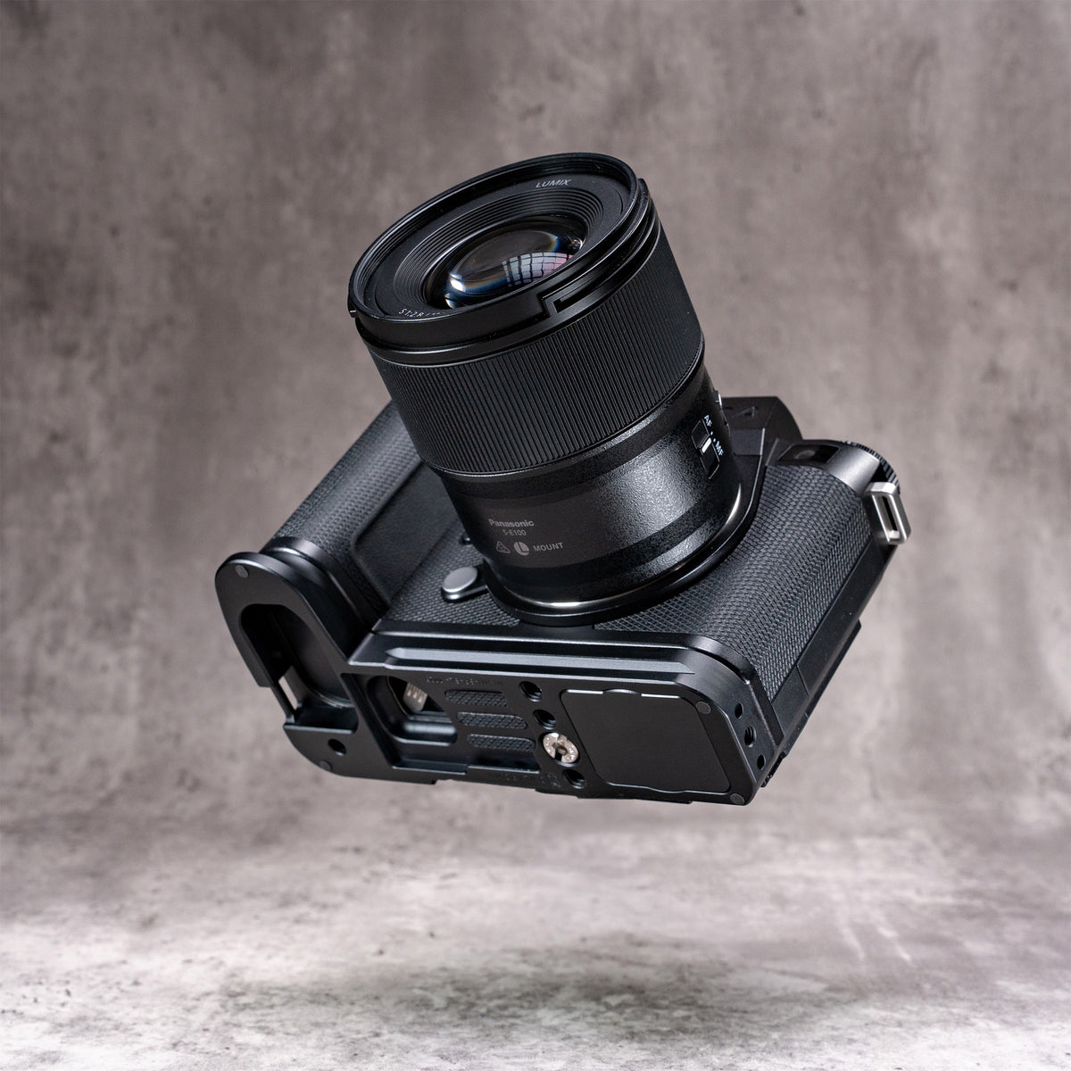 Leica SL3 and lens angled to show the Arca profile machined into the base of the Owlkrown FlexPlate