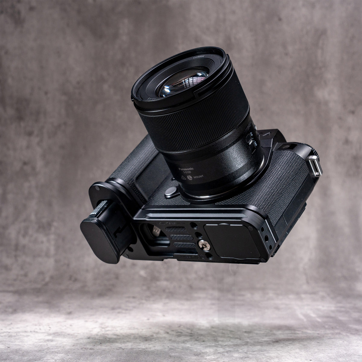 Leica SL3 with lens, low angle showing the Owlkrown FlexPlate along the base of the camera