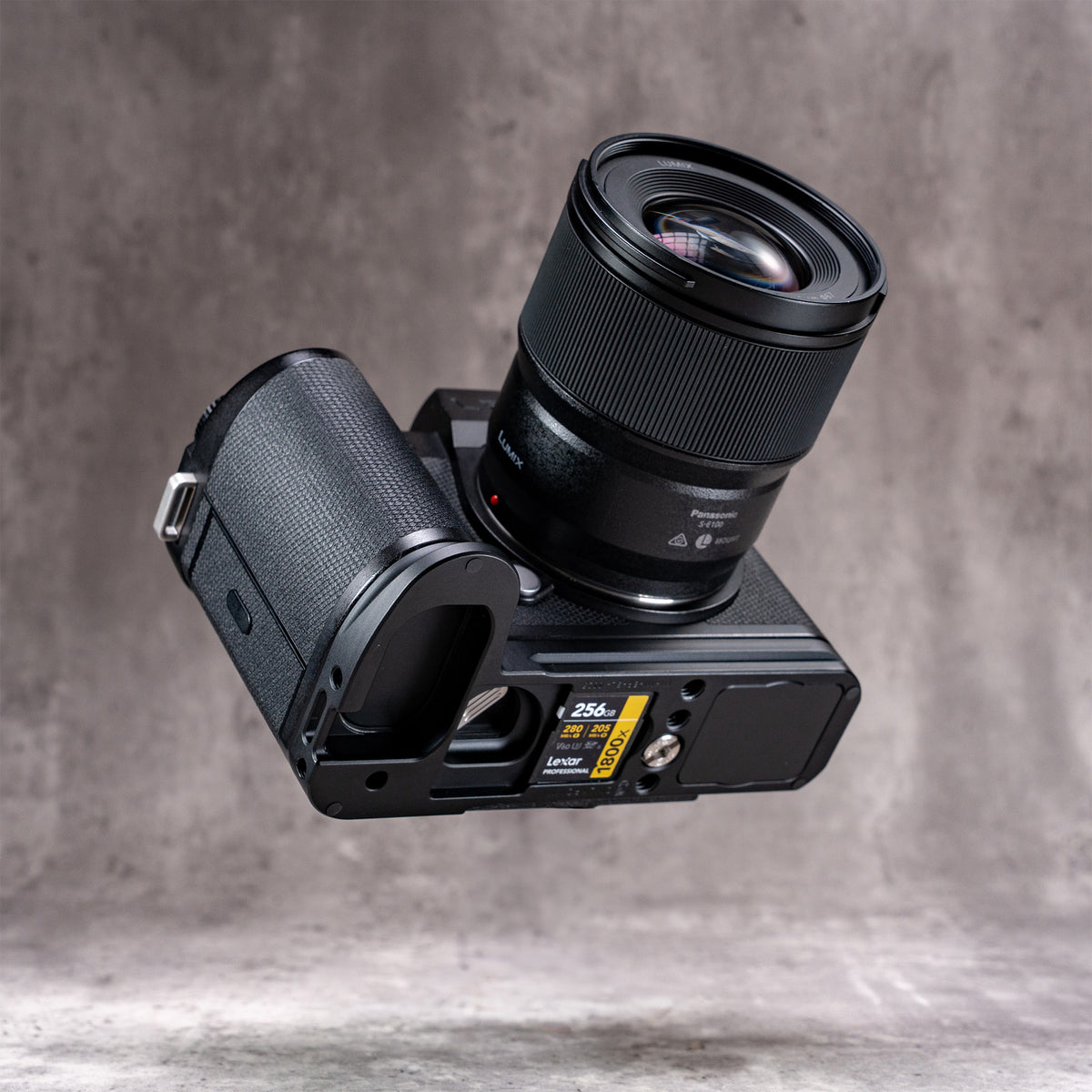Leica SL3 and lens angled to show the spare SD card stored in the Owlkrown FlexPlate