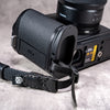 Close view of the Owlkrown FlexPlate for Leica SL3 with a wrist strap attached at the side lug