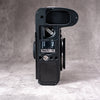 Underside of the Owlkrown FlexPlate for Leica SL3, showing the external card bay with a spare SD card loaded