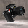Leica SL3 fitted with the Owlkrown FlexPlate, angled three quarter view with lens attached