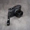 Leather Thumb Strap - Stealth hanging from a Leica M lug