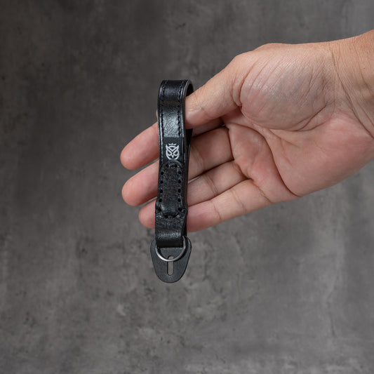 Leather Thumb Strap - Stealth held in hand to show size