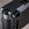 Owlkrown M-EyeKup in Black Chrome threaded onto a Leica M rangefinder eyepiece, angled top view