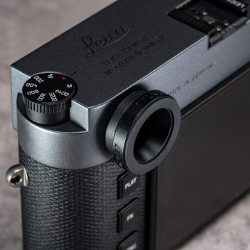 Owlkrown M-EyeKup in Black Chrome threaded onto a Leica M rangefinder eyepiece, angled top view