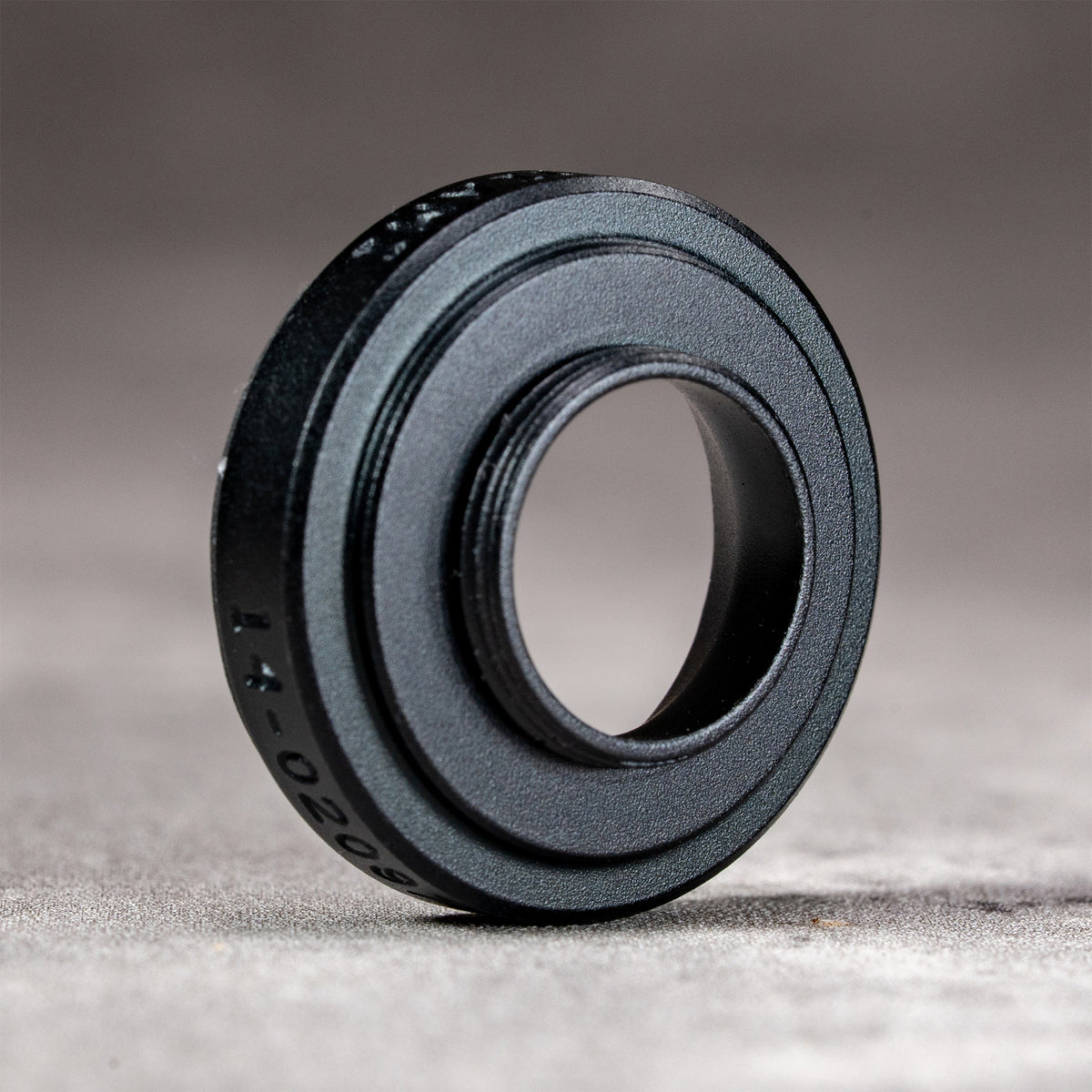 Black Chrome M-EyeKup showing the machined aluminum body and eyepiece opening