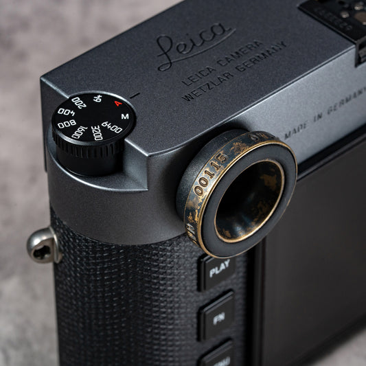 Owlkrown M-EyeKup in Black Patina threaded onto a Leica M rangefinder eyepiece, angled top view