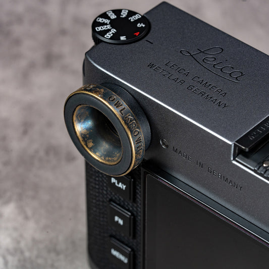 Black Patina M-EyeKup installed on a Leica M, angled view showing the Owlkrown engraving