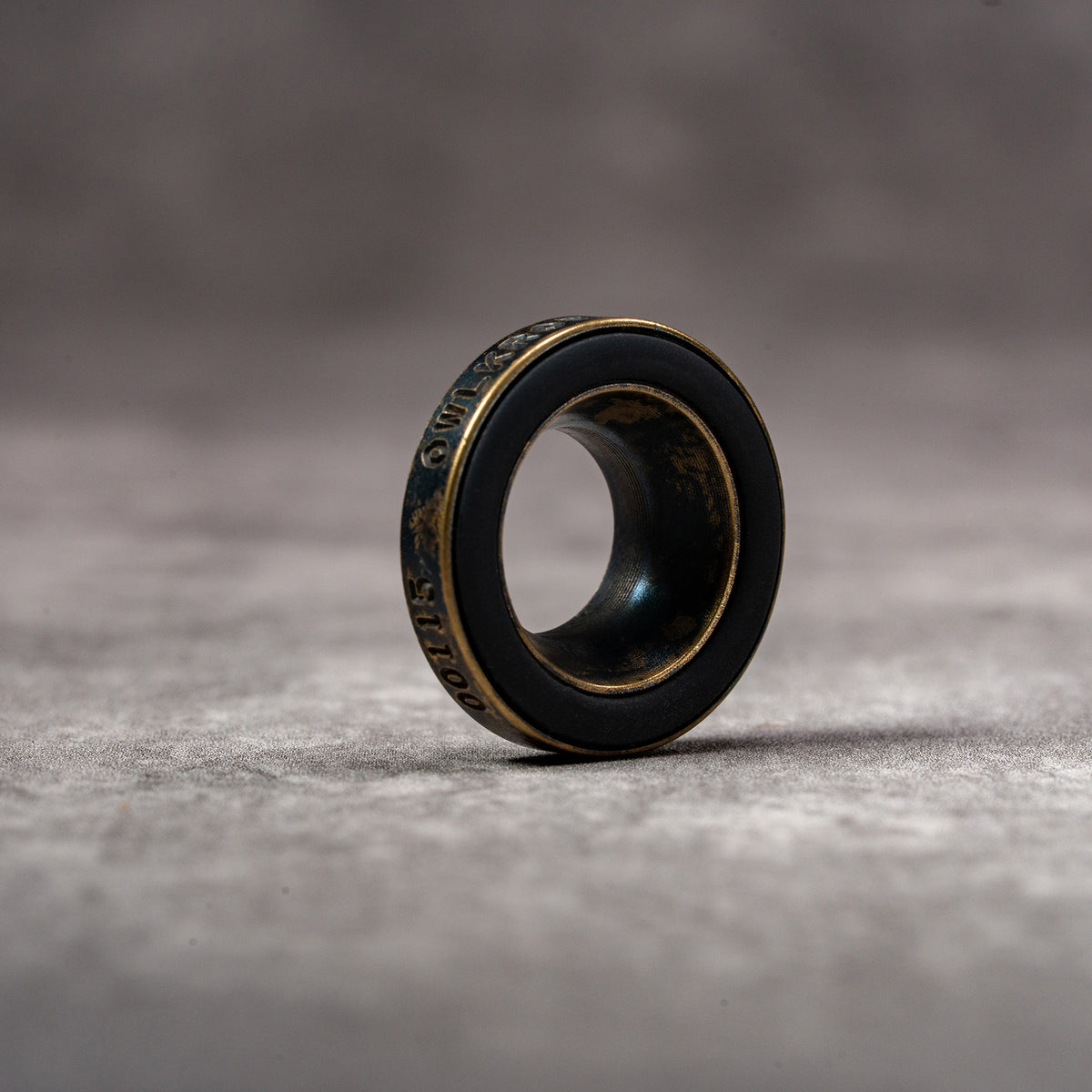 Black Patina M-EyeKup showing the aged brass body and silicone pad