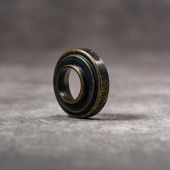 Black Patina M-EyeKup at an angle, showing the threaded barrel