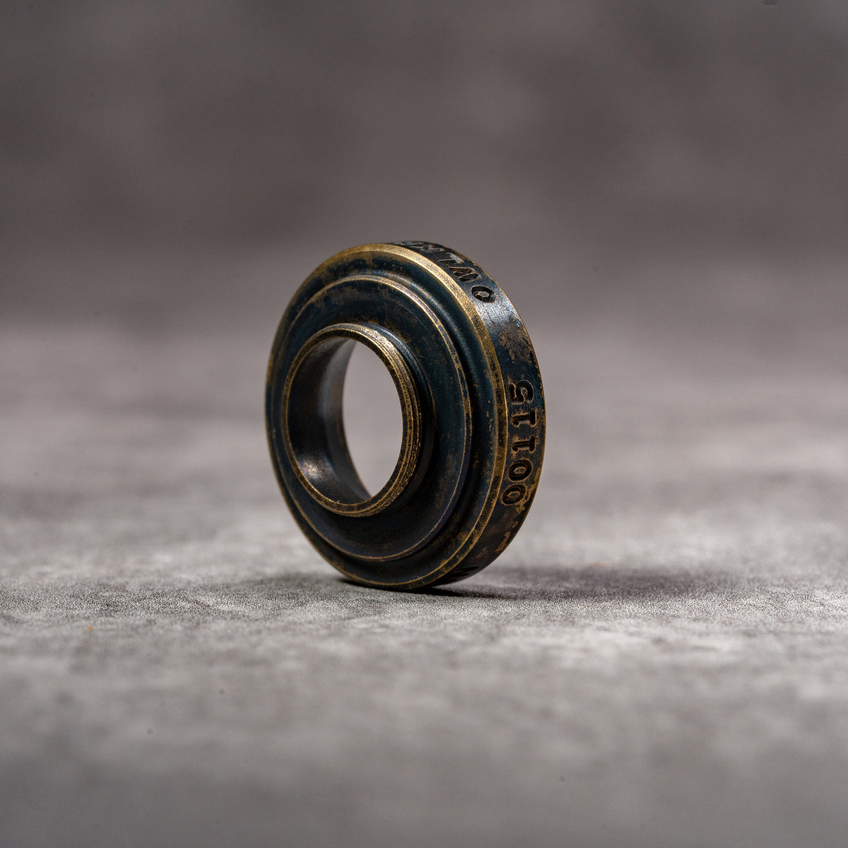 Black Patina M-EyeKup at an angle, showing the threaded barrel