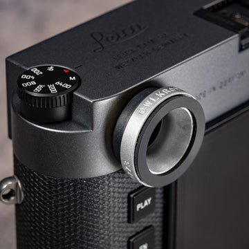 Owlkrown M-EyeKup in Silver Chrome threaded onto a Leica M rangefinder eyepiece, angled top view