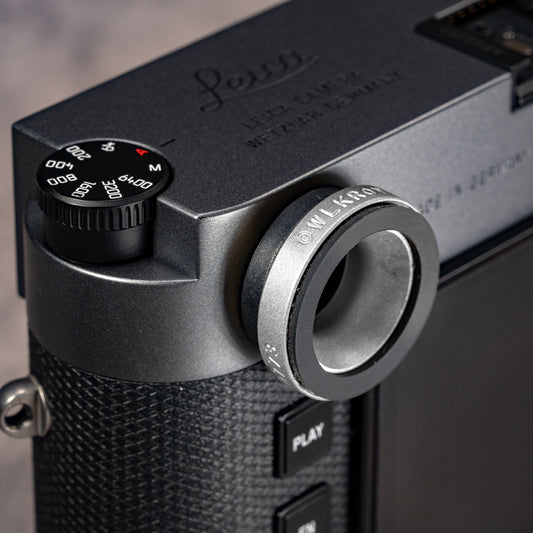Owlkrown M-EyeKup in Silver Chrome threaded onto a Leica M rangefinder eyepiece, angled top view