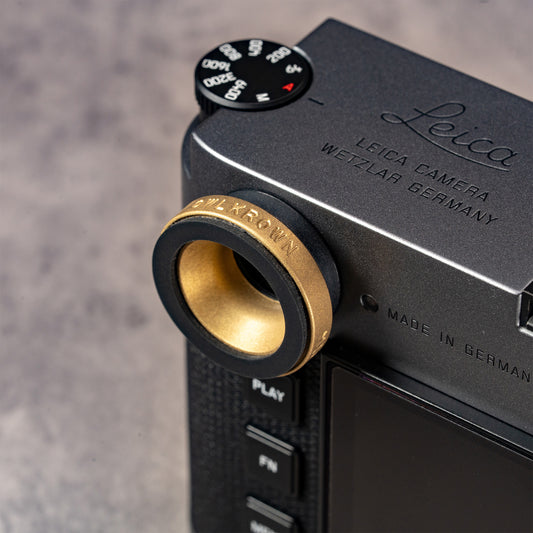 Solid Brass M-EyeKup installed on a Leica M, angled view across the top plate