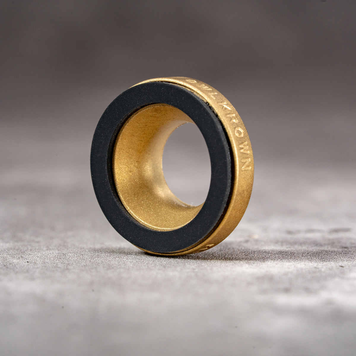 Owlkrown M-EyeKup in Solid Brass, three-quarter view showing the Owlkrown engraving